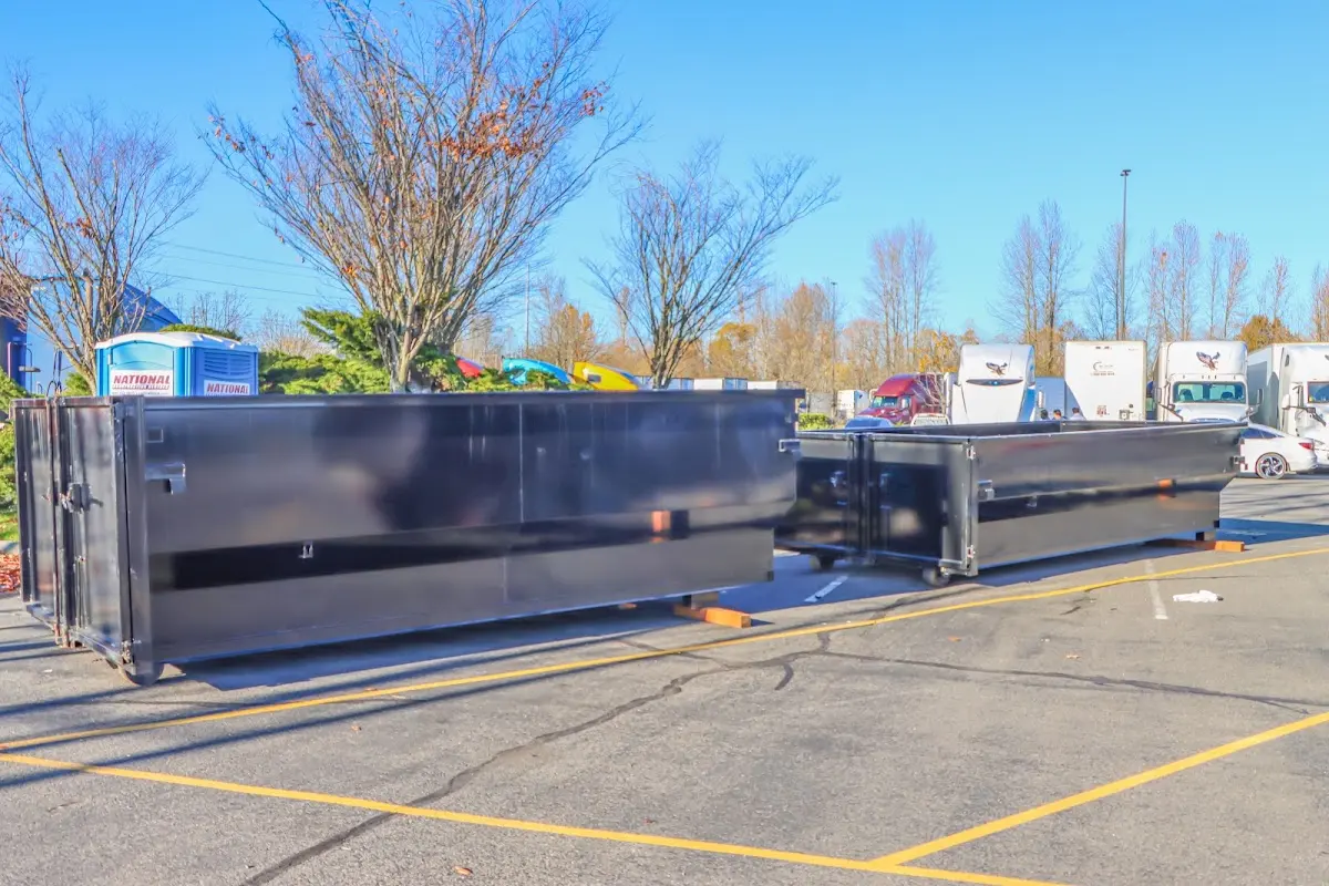 Professional dumpster rental service with roll-off container on residential driveway in Davie